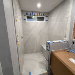 Bright, contemporary bathroom with minimalist design and natural light accents in conatruction.