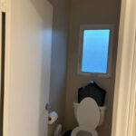 Dated bathroom layout with enclosed shower and original hardware prior to remodel.